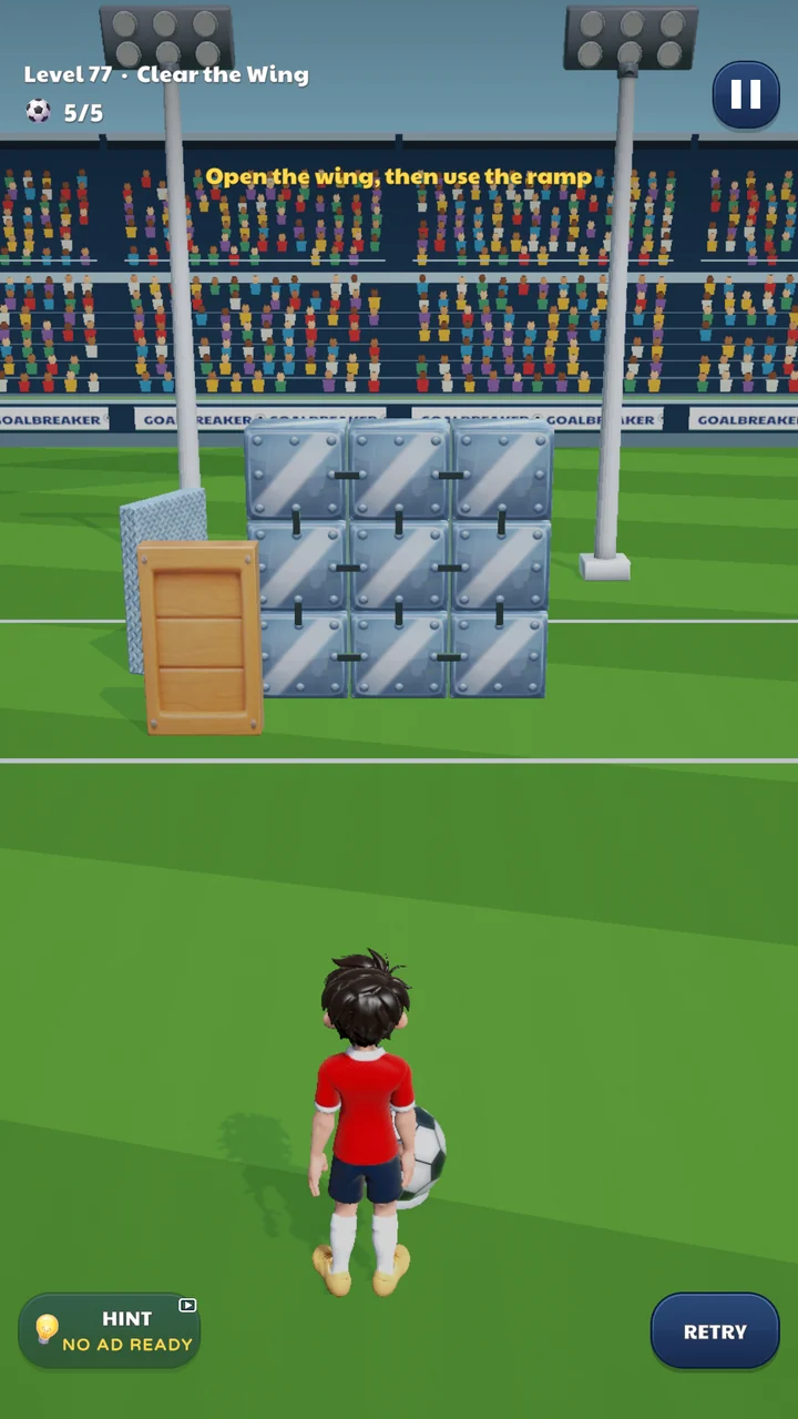 A Goalbreaker puzzle: a striker faces a wall of metal blocks, a wooden barrier and a ramp